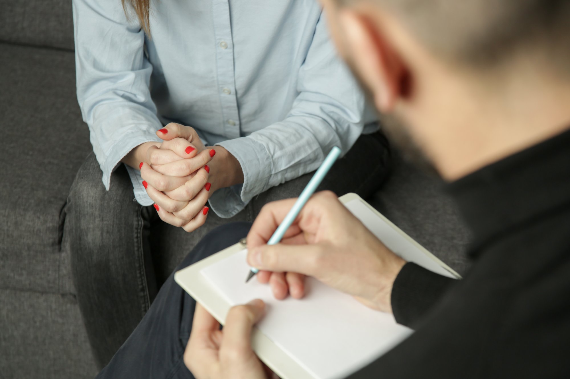 Depressed woman during psychotherapy. Young woman talking to her therapist. Anxiety or mental health therapy, marriage, family and carieer counseling