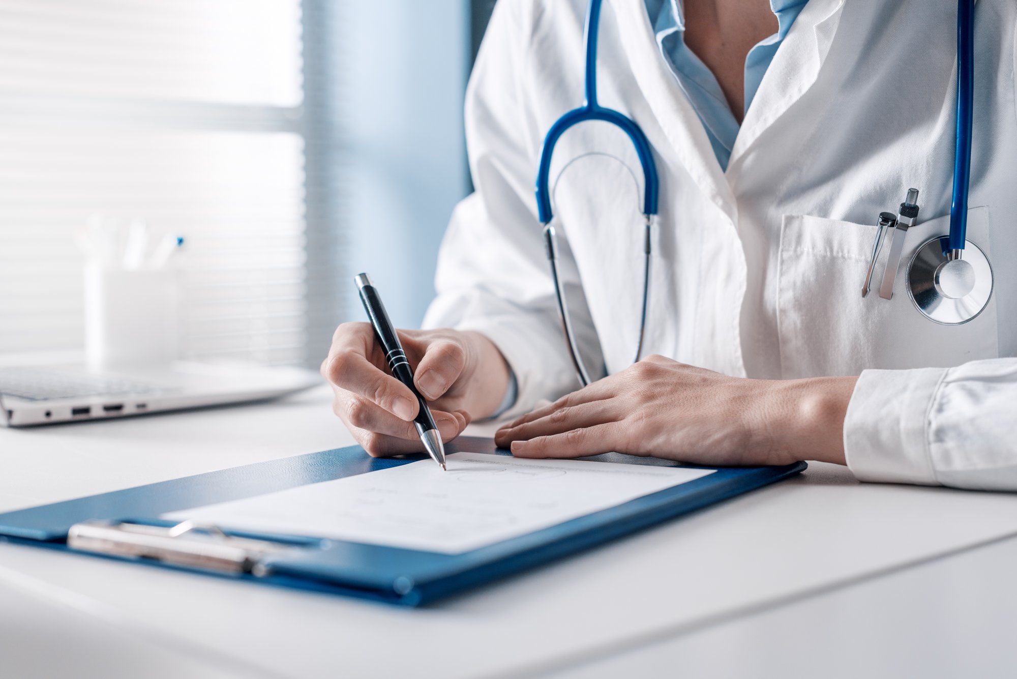 Doctor writing a medical prescription