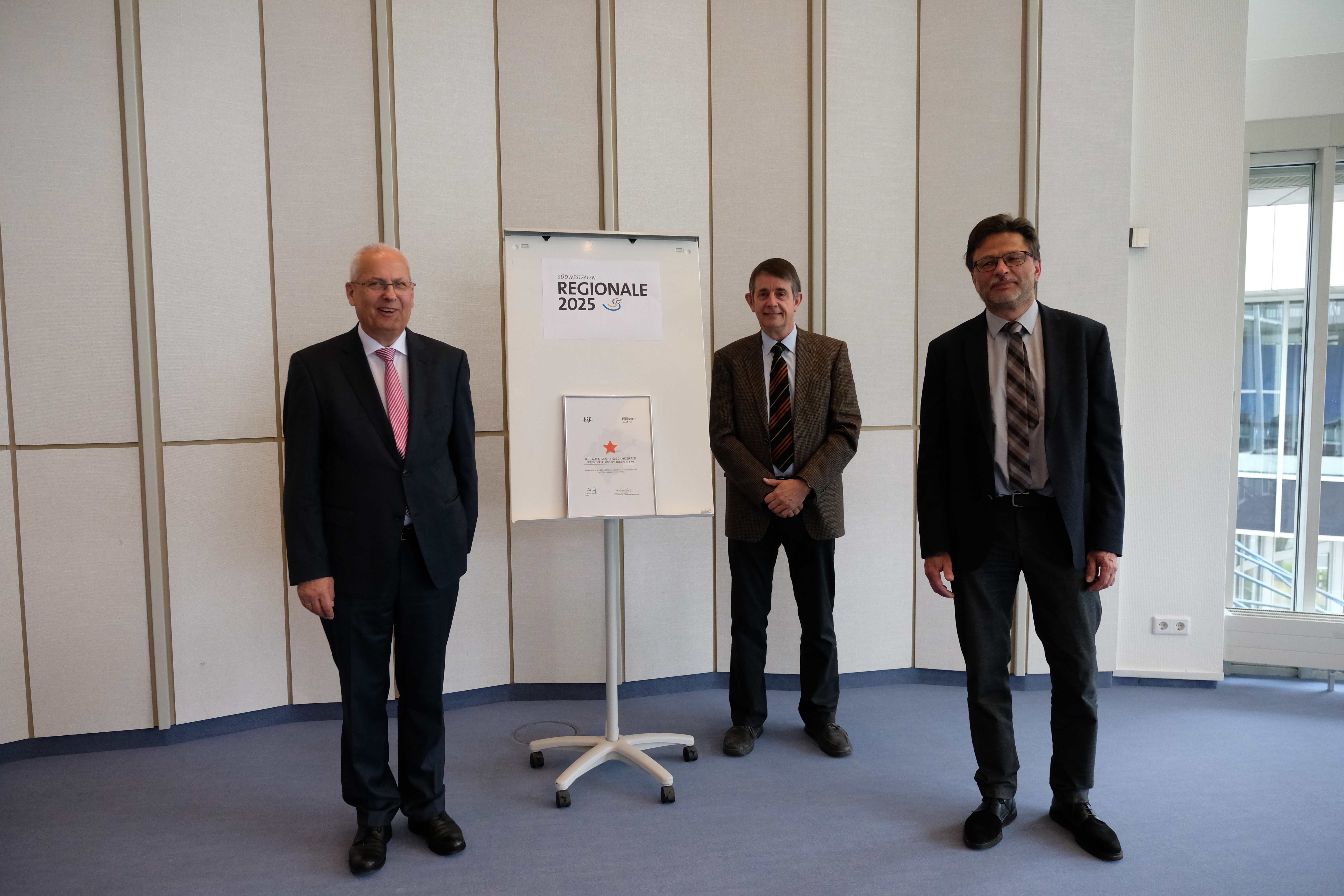 Den ersten Stern der Regionale 2025 überreichte Landrat Dr. Karl Schneider für die Idee "Digitalisierung: viele Chancen für die öffentlichen Musikschulen in Südwestfalen" an die Projektträger Prof. Dr. Stephan Breide und Ullrich Papencordt (v.ln.r.).